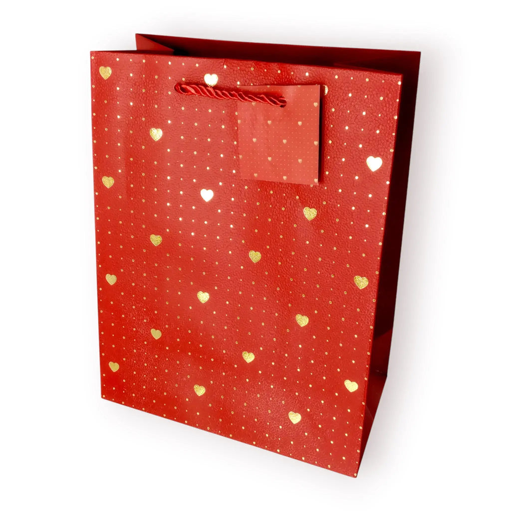 Bolsa de regalo mediana con estampado de corazones dorados metalizados sobre fondos pastel.
