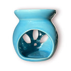 Difusor aromático de cerámica esmaltada modelo clásico para esencias y velas de té, disponible en colores blanco, rosado y azul celeste.