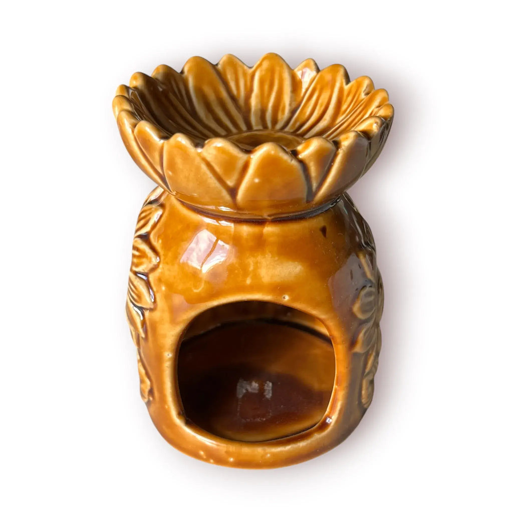 Difusor aromático de cerámica esmaltada con relieve de girasol y cuenco en forma de flor, disponible en colores blanco, café y beige.