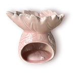 Difusor aromático de cerámica esmaltada con relieve e ingenioso cuenco en forma de hoja, disponible en colores rosado pastel y café.